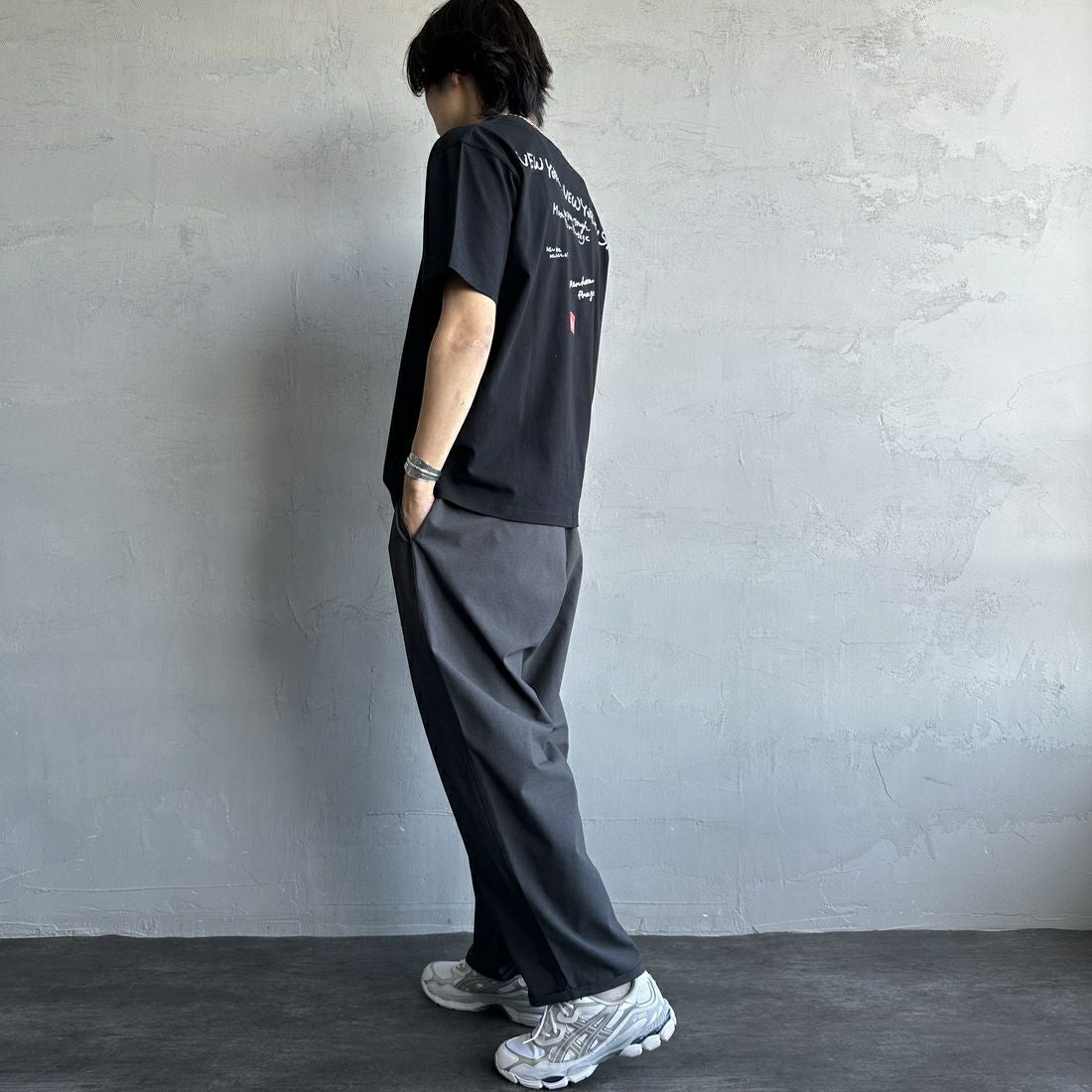 MANHATTAN PORTAGE [マンハッタンポーテージ] 別注 ランダムロゴ バックプリントTシャツ [25SSMP-IN66-JF] BLACK &&モデル身長：179cm 着用サイズ：L&&