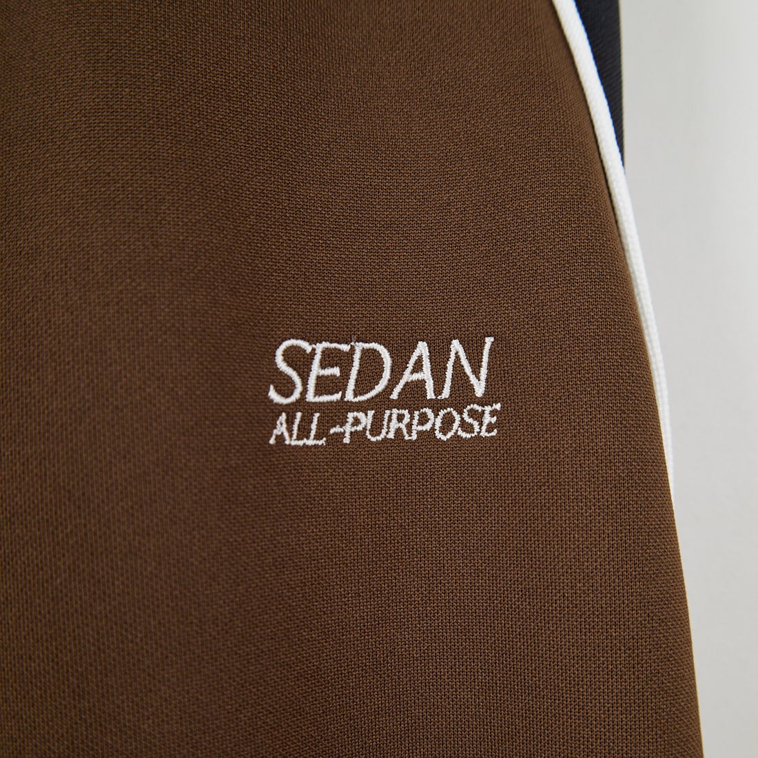 SEDAN ALL-PURPOSE [セダン オールパーパス] OGロゴ トラックパンツ [SD25F-PT05] BRN/BLK