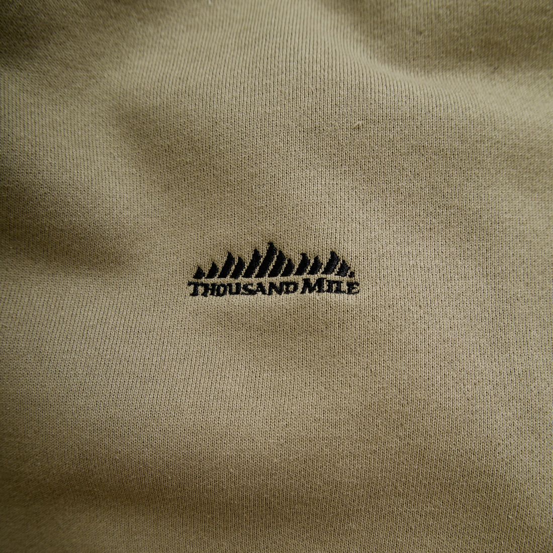 THOUSAND MILE [サウザンド マイル] 別注 バックプリント クルーネックスウェット [TM252UK50520-JF] 23 BEIGE