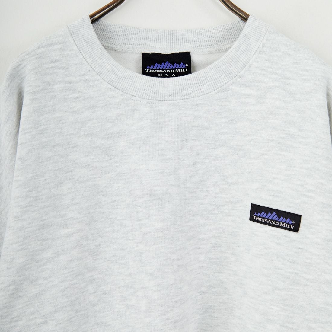 THOUSAND MILE [サウザンド マイル] 別注 ワンポイントロゴ クルーネックスウェット [TM252UK50510-JF] 11 LT.GRAY