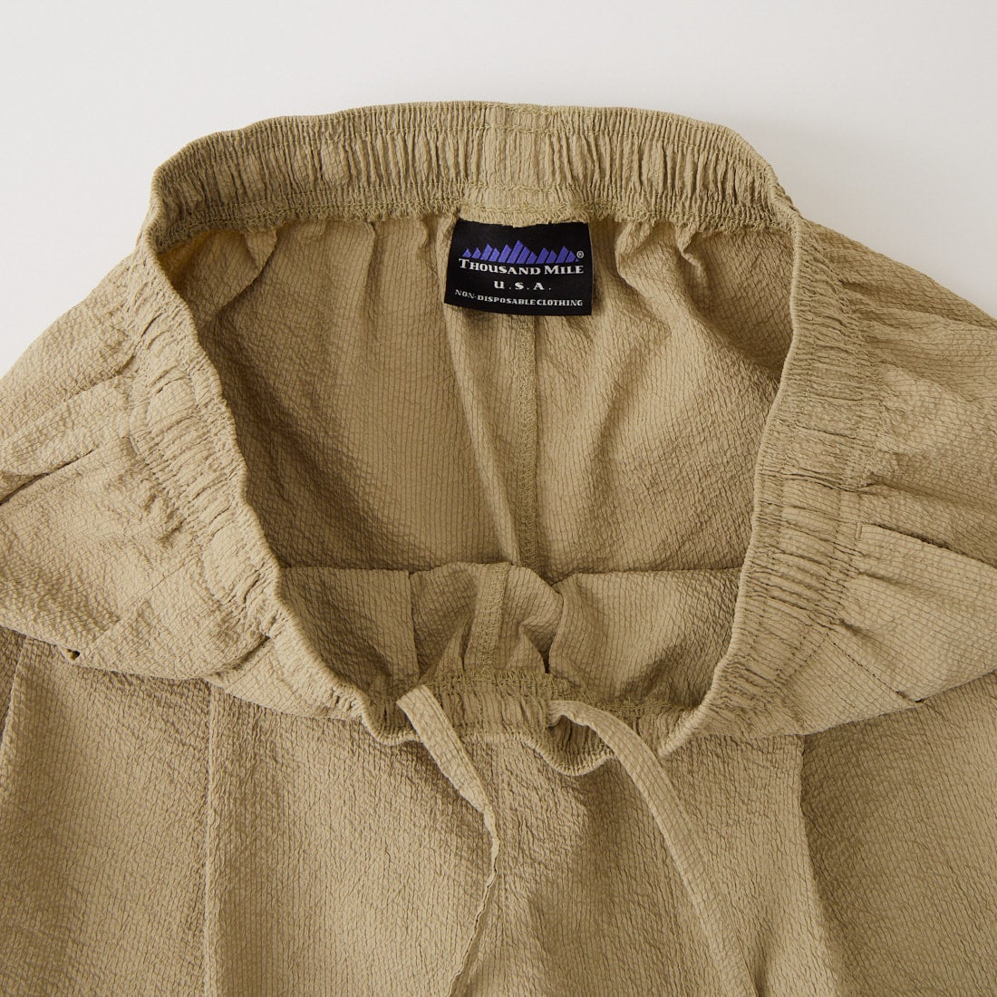 THOUSAND MILE [サウザンド マイル] 別注 シアサッカー サマーバケーション ワイドパンツセットアップ [TM261SS50812-JF] 23 BEIGE